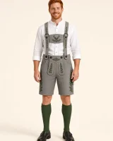 Man in his thirties wearing the Brecherspitz smoke grey lederhosen with a white stand-collar Trachten shirt, full-length
