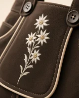 Close-up of white edelweiss trail and buttons on the espresso cow suede of the Hochgern